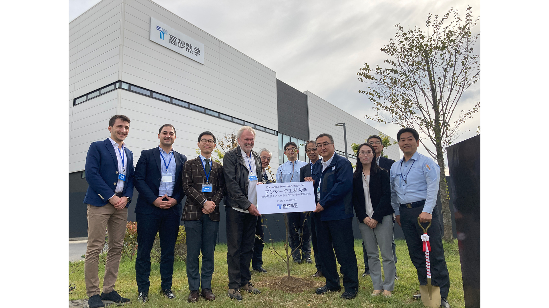 Group photograph of the DTU Sustain researchers and the employees of the engineering company who have just planted a tree